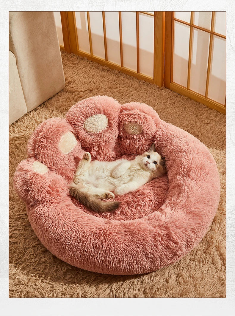 Cat lounging on pink plush sofa bed