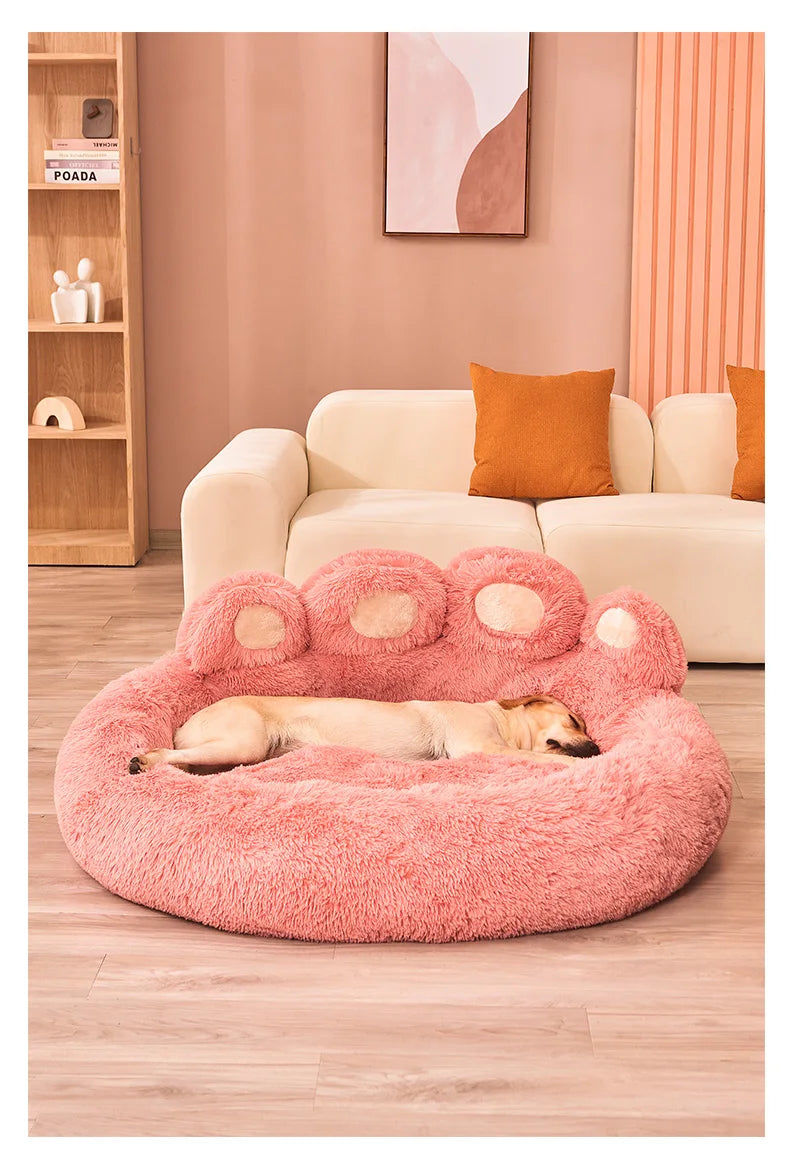 Dog sleeping on pink plush sofa bed