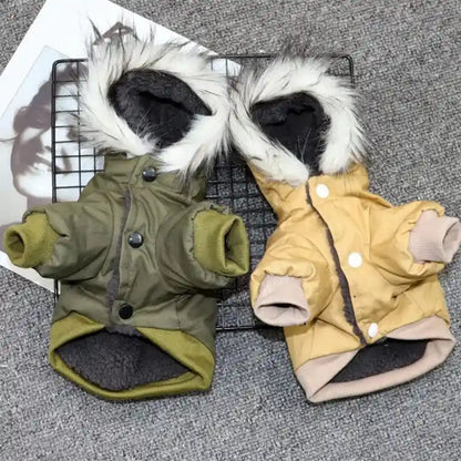 Green and beige dog coats with fur-trimmed hoods.