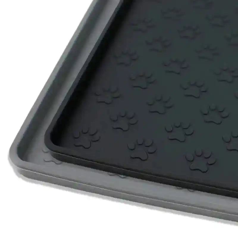 Close-up of black and gray silicone pet mats with paw prints