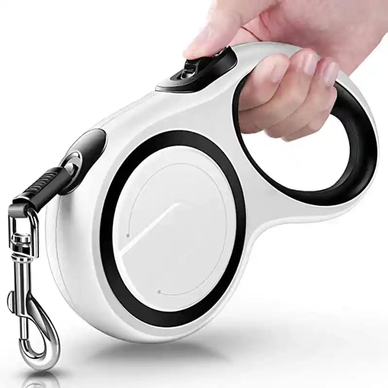 Hand holding white retractable dog leash with anti-slip handle.